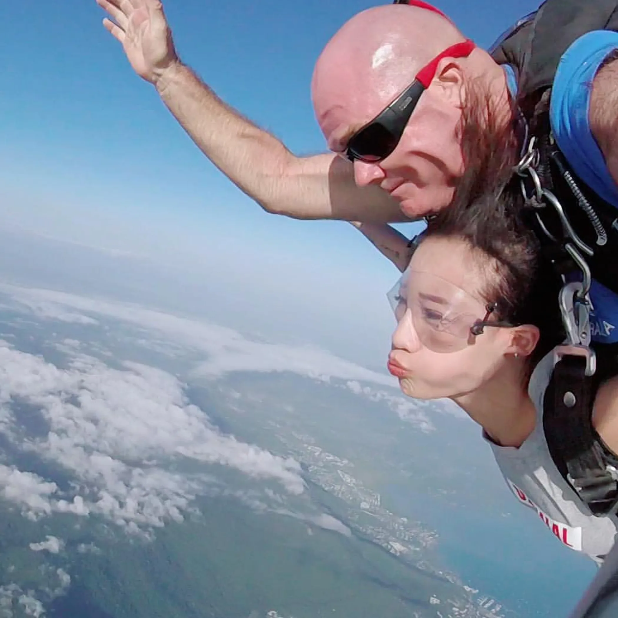 skydiver over airlie beach landscape