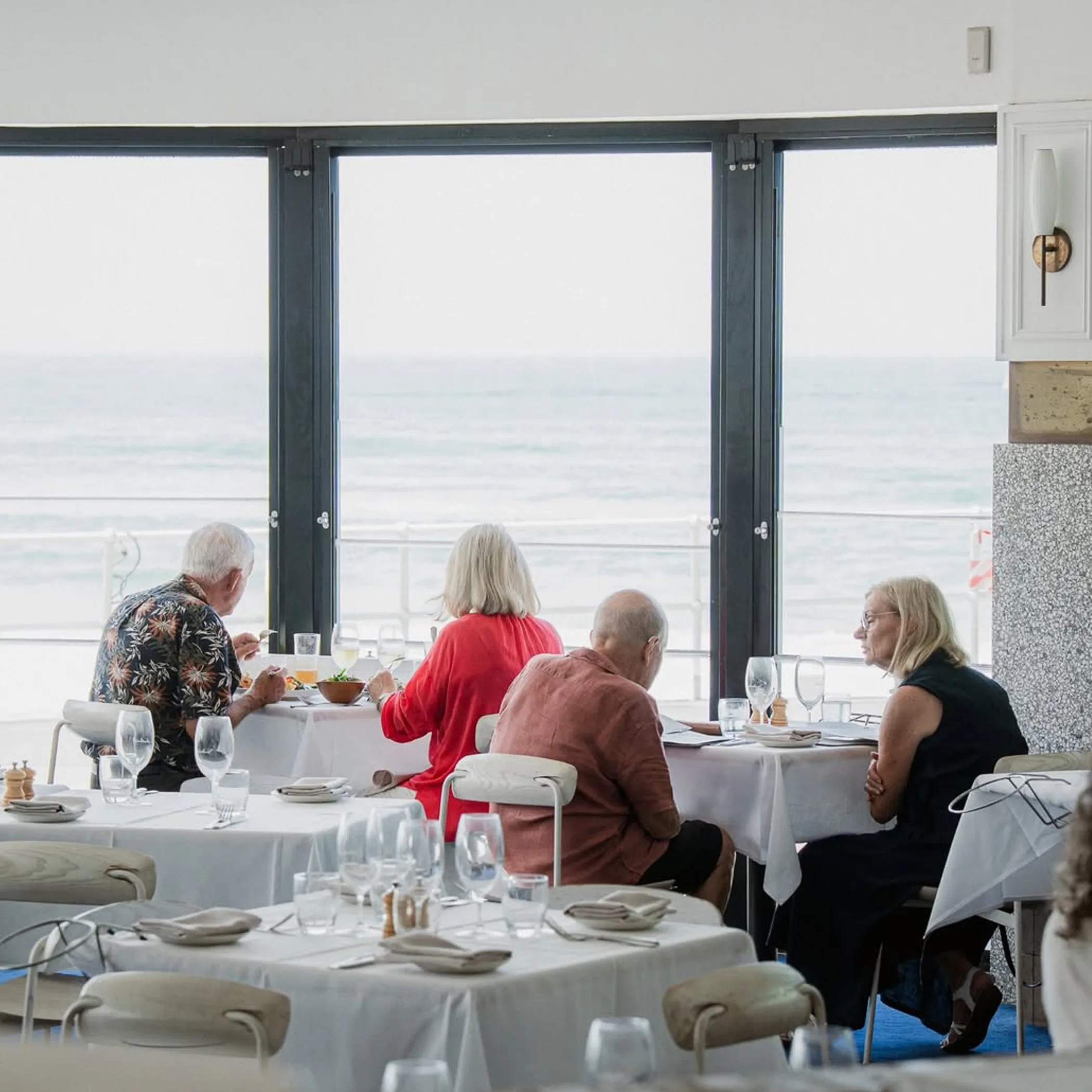 diners enjoying coastal restaurant meal